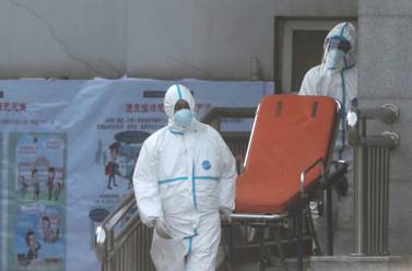 Medical staff transfer patients to Jinyintan hospital where patients infected with a new strain of Coronavirus identified as the cause of the Wuhan pneumonia outbreak are treated in Wuhan, Hubei province, China, January 20, 2020. EPA/STRINGER CHINA OUT