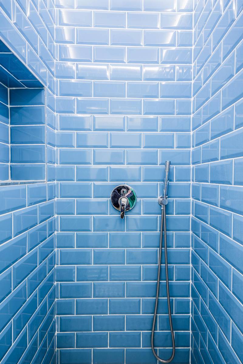 Clean grout with a toothbrush dipped in bleach. Unsplash