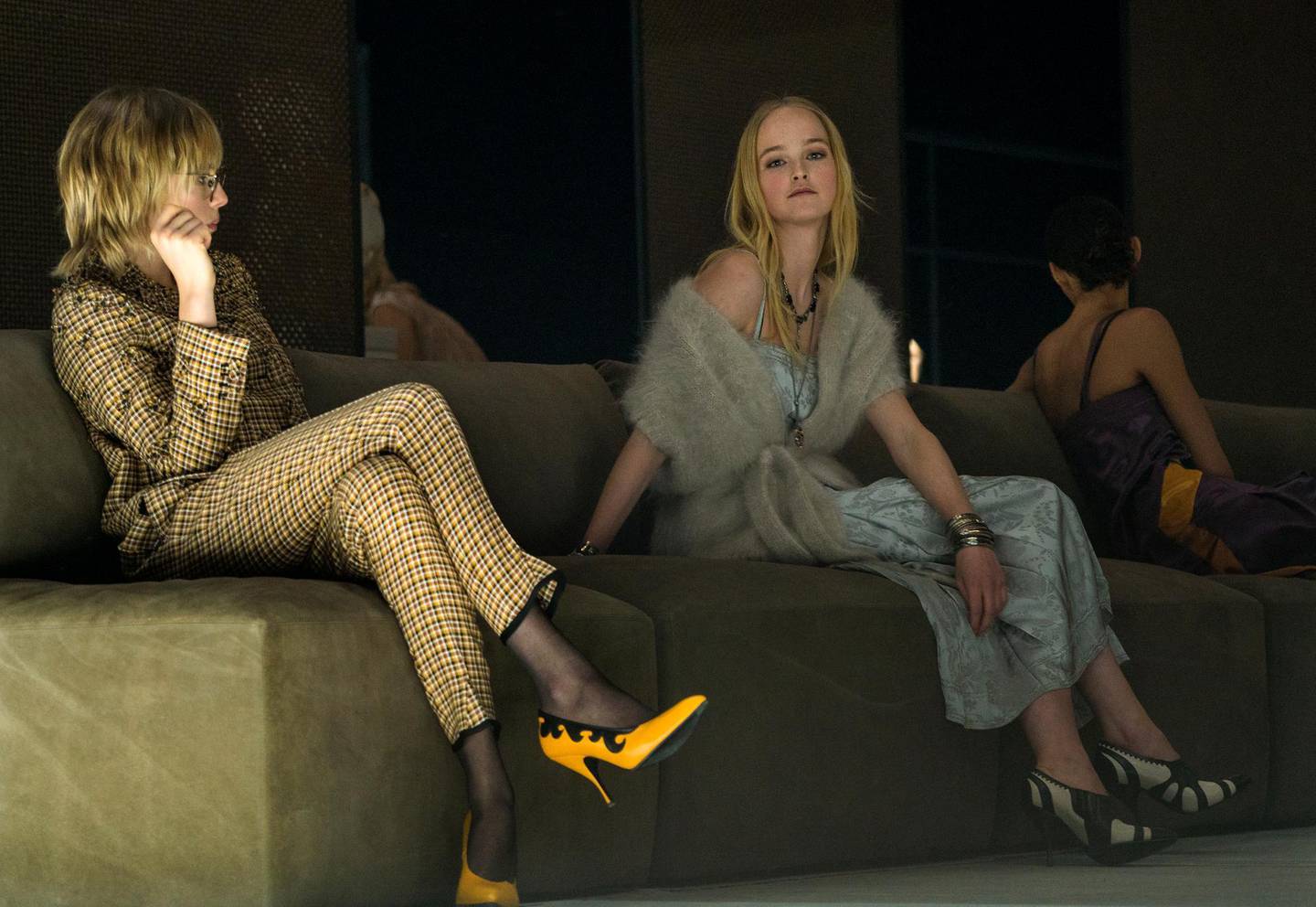 Models, wearing fashion from the Bottega Veneta collection, sit on furniture that is part of the runway show during Fashion Week in New York, Friday, Feb. 9, 2018. (AP Photo/Craig Ruttle)