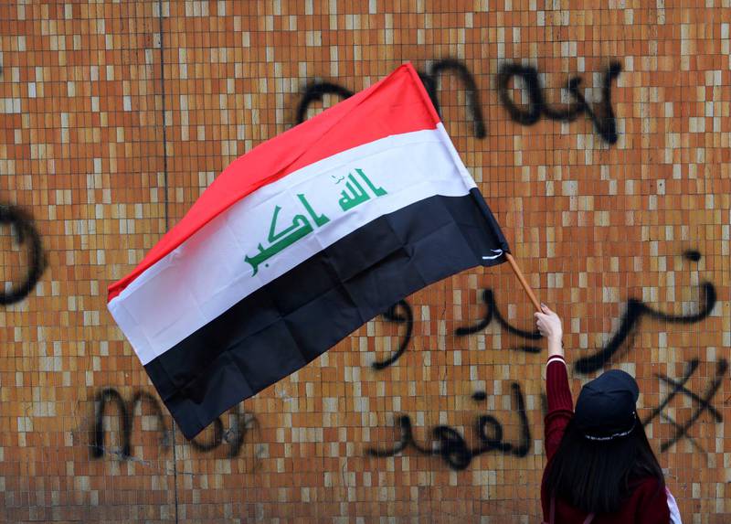 A female university student carries the Iraqi national flag during a strike and protests in central Baghdad, Iraq.  EPA