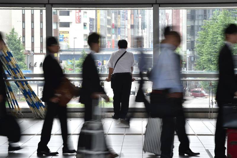 People cross a concourse in Tokyo. Kazuhiro Nogi/AFP