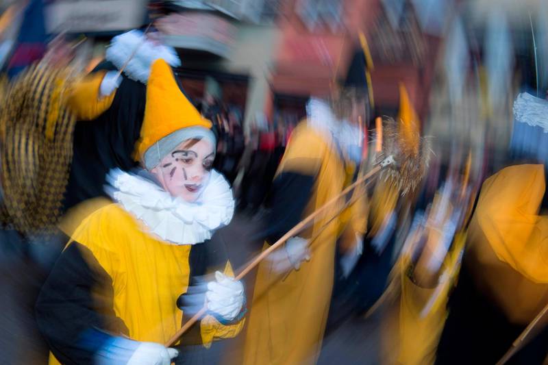 A child, dressed up as a clown, takes part in the "Narrensprung" (Jump of the Fools) carnival parade in Rottweil, southern Germany. Thomas Kienzle / AFP Photo