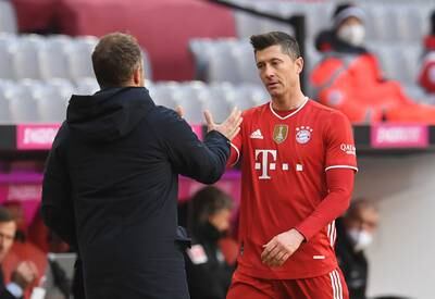 Bayern Munich's Robert Lewandowski shakes hands with coach Hansi Flick. Reuters