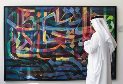 ABU DHABI, UNITED ARAB EMIRATES - An attendee looking at an art on display at the Al Burda Festival, Shaping the Future of Islamic Art and Culture at Warehouse 421, Abu Dhabi.  Leslie Pableo for The National for Melissa Gronlund’s story