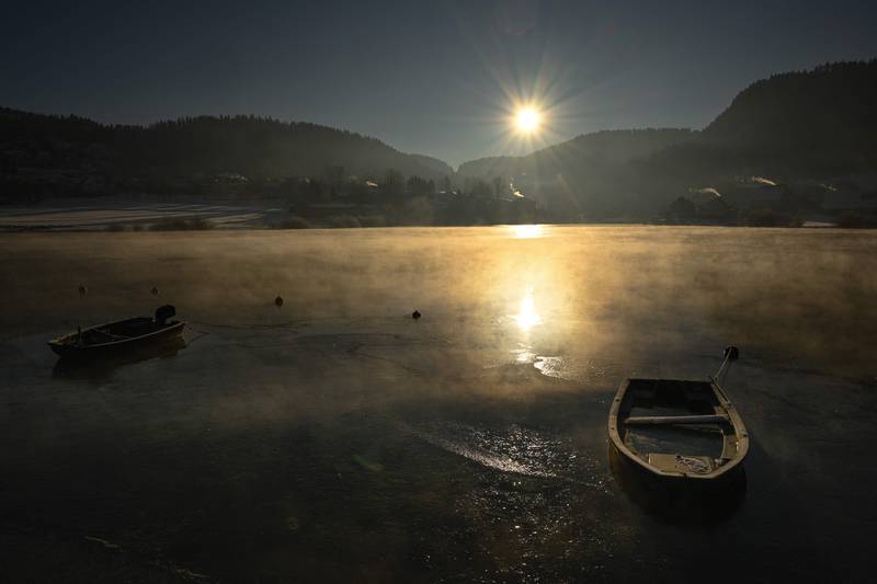 Boats sit on a frozen lake in Villers-Le-Lac, eastern France. AFP