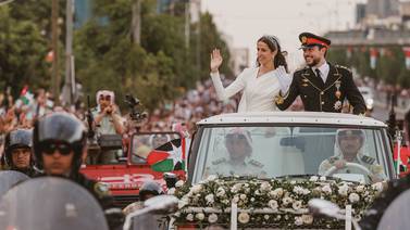 Jordanian Crown Prince Hussein bin Abdullah and his wife Princess Rajwa wave during their wedding parade in Amman. EPA