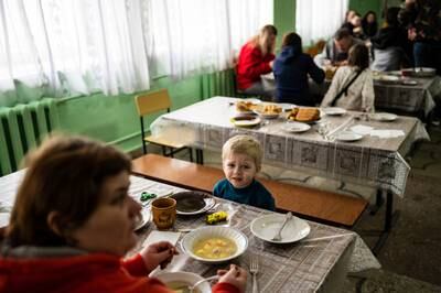 Families eat in the shelter. Reuters
