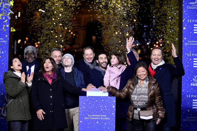 French actor Tahar Rahim, Mayor Anne Hidalgo and guests switch on the lights in Paris. AFP