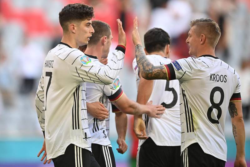 TOPSHOT - Germany's forward Kai Havertz (L) celebrates with Germany's midfielder Toni Kroos after scoring his team's third goal during the UEFA EURO 2020 Group F football match between Portugal and Germany at Allianz Arena in Munich, Germany, on June 19, 2021. / AFP / POOL / PHILIPP GUELLAND
