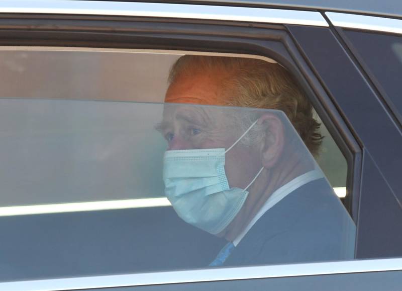 Prince Charles adjusts his maks as he leaves Jesus House church. Reuters