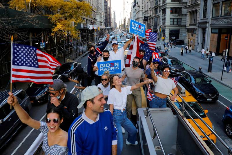 A group of friends who live in New York City celebrate after former Vice President Joe Biden was declared the winner of the 2020 U.S. presidential election as they ride down Fifth Avenue in a rented open top double decker bus in Manhattan, New York City, U.S. Reuters