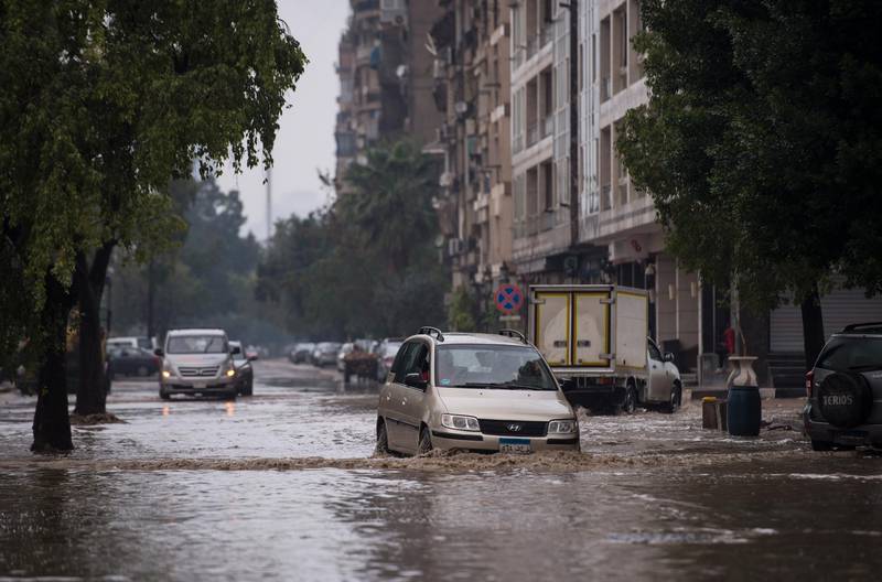 Vehicle pass a flooded street amid a heavy rain shower in Cairo. EPA