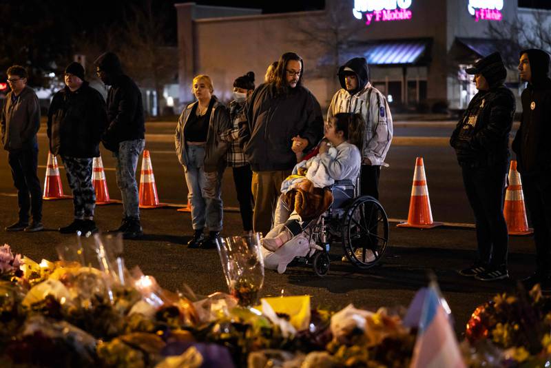 Richard Fierro consoles his daughter, Kassandra, whose boyfriend, Raymond Green Vance, was among those killed. Mr Fierro, a US Army veteran, is credited with subduing the gunman. Getty Images / AFP 