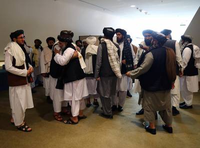 Members of the Taliban delegation gather ahead of an agreement signing between them and US officials in Doha, Qatar. Reuters