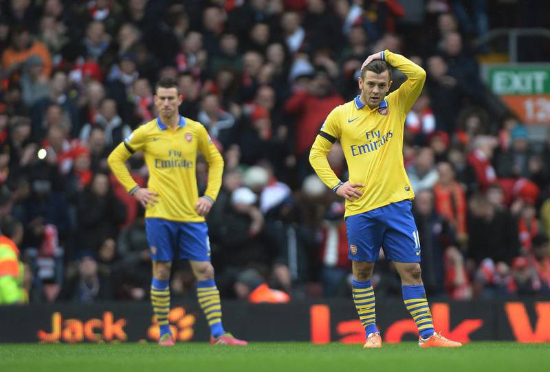 Arsenal midfielder Jack Wilshere, right, looks dejected after his side were beaten 5-1 at Anfield by Liverpool. Peter Powell / EPA