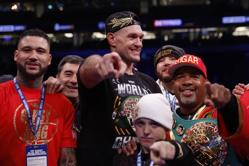 Tyson Fury celebrates with his team and son after beating Derek Chisora. Reuters