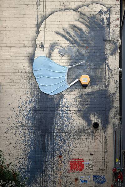BRISTOL, ENGLAND - APRIL 27: The graffiti artwork by Banksy named 'Girl with a Pierced Eardrum' is seen with a protective face mask at Hannover Place on April 27, 2020 in Bristol, England. British Prime Minister Boris Johnson, who returned to Downing Street this week after recovering from Covid-19, said the country needed to continue its lockdown measures to avoid a second spike in infections. (Photo by Dan Mullan/Getty Images)