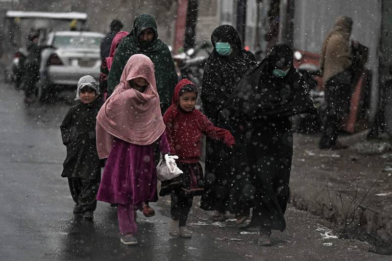 Women and children brave the chilly weather.