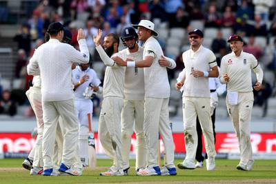 England celebrate as South Africa's Duanne Olivier is caught by England's Ben Stokes off the bowling of Moeen Ali, with beard centre left, as England win the test match during day four of the Fourth Test at Emirates Old Trafford in Manchester, England, Monday Aug. 7, 2017. (Anthony Devlin/PA via AP)