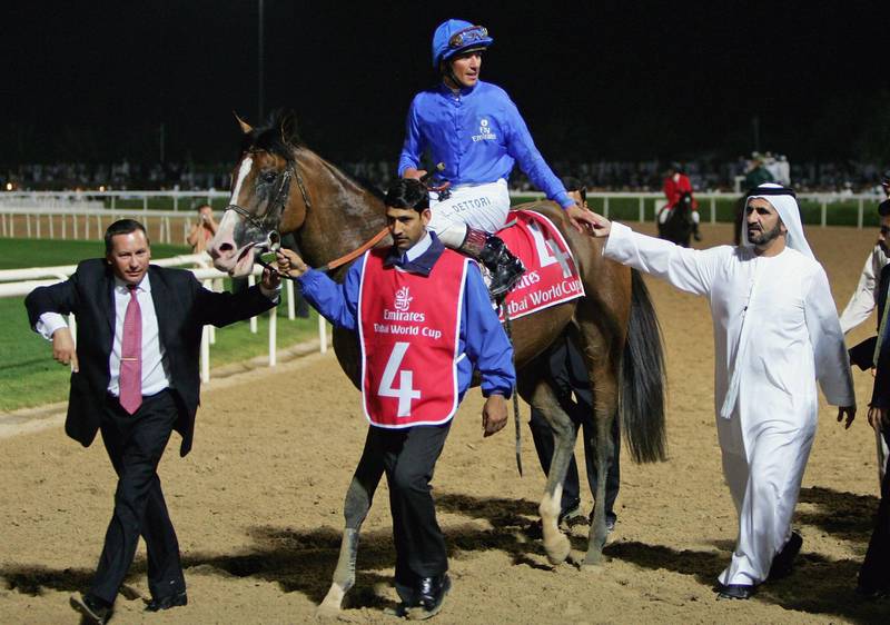 DUBAI, UNITED ARAB EMIRATES - MARCH 25: The ruler of Dubai Sheikh Mohammed bin Rashed Al Maktoum (R) congratulates Electrocutionist riden by jockey Frankie Dettori (C) after winning race 7 the Dubai World Cup during the 2006 Dubai World Cup held at Nad Al Sheba Racecourse on March 25, 2006 in Dubai, United Arab Emirates. It is the eleventh running of the world's richest horse race, the US$6,000,000 Dubai World Cup.  (Photo by Scott Barbour/Getty Images)