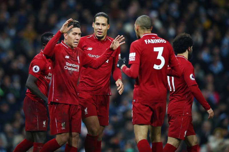 Roberto Firmino of Liverpool celebrates after scoring his team's first goal with his team mates. Getty Images