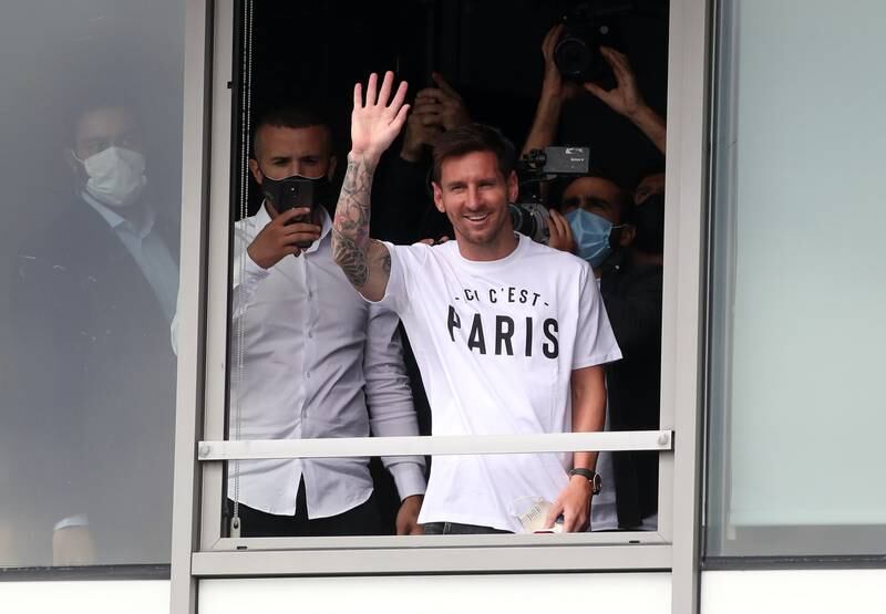 Lionel Messi, 34, waves to the fans outside Le Bourget Airport.