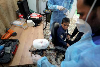 Ahmed Al-Deeb waits for his mask to be fitted at the clinic. Reuters