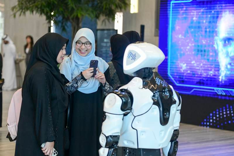 Guests entertained by a robot at the Mohamed bin Zayed University of Artificial Intelligence (MBZUAI) inaugural commencement ceremony in Abu Dhabi. Khushnum Bhandari / The National 