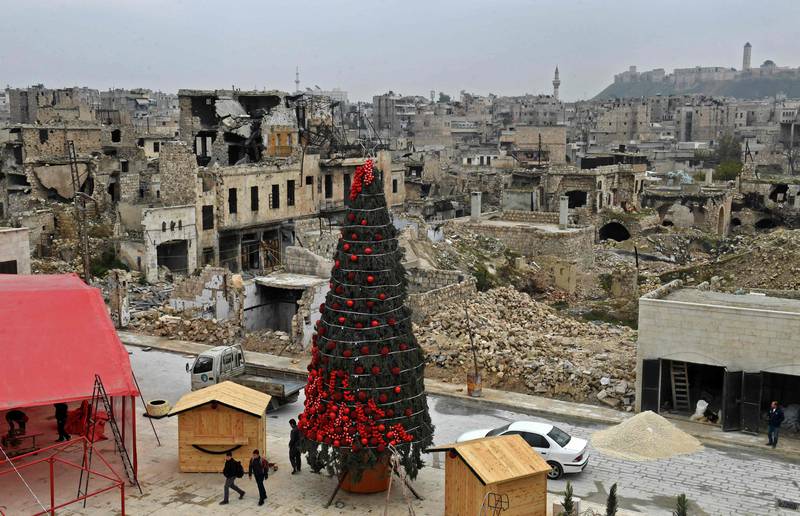 Workers set up a Christmas tree in Al Hatab Square, in Aleppo, northern Syrian. The city has been devastated in the country's civil war. AFP