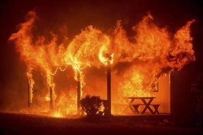 A house burns as the Butte fire rages through Mountain Ranch, California. Evacuation orders were expanded to thousands of homes in northern California’s Sierras on Friday as the rapidly spreading wildfire roared for a third day through drought-parched timber and brush, threatening mountain communities. Noah Berger / Reuters