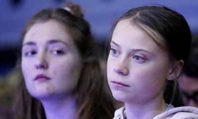 FILE PHOTO: Swedish climate change activist Greta Thunberg and Swiss activist Loukina Tille attend a session at the 50th World Economic Forum (WEF) annual meeting in Davos, Switzerland, January 21, 2020. REUTERS/Denis Balibouse/File Photo