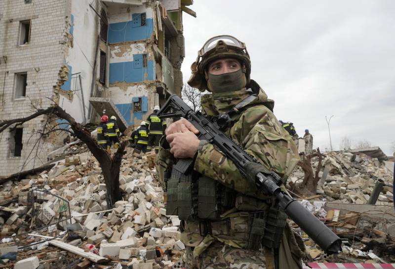 A Ukrainian soldier stands in front of a destroyed apartment block following Russian shelling in Borodyanka on Wednesday. AP Photo