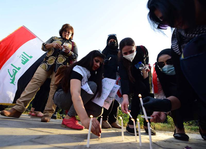 Women light candles and pray for the victims of protests at Tahrir Square in central Baghdad. EPA