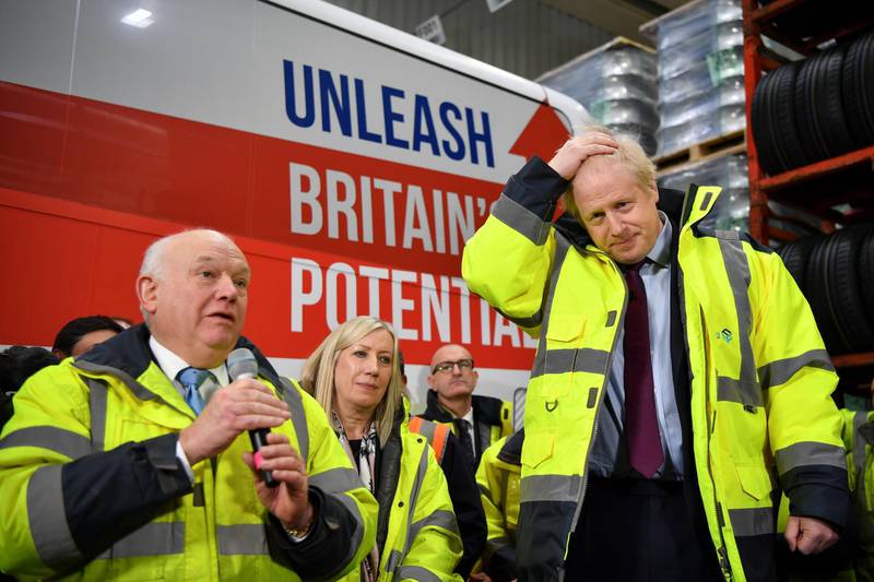 WASHINGTON, UNITED KINGDOM - DECEMBER 9: Fergusons Transport CEO Alan Ferguson (L) speaks as Britain's Prime Minister Boris Johnson (R) looks on during a general election campaign visit to Fergusons Transport December 9, 2019 in Washington, England. Britain will go to the polls on December 12, 2019 to vote in a pre-Christmas general election. (Photo by Ben Stansall - WPA Pool/Getty Images)