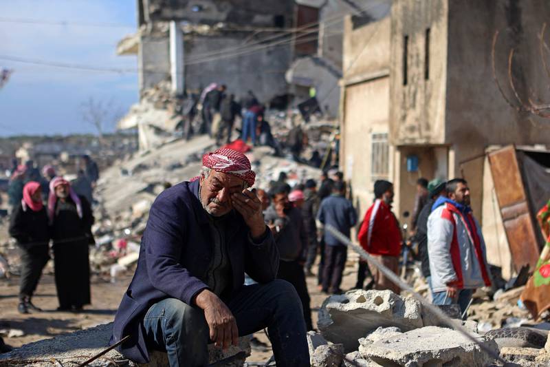A Syrian man cries as he sits on the rubble of a collapsed building in the rebel-held town of Jindayris. AFP