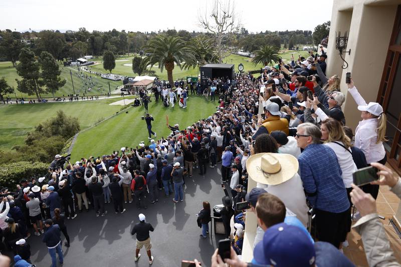 Spectators watch Tiger Woods on the first tee at the Genesis Invitational golf tournament at Riviera Country Club, Los Angeles. AP