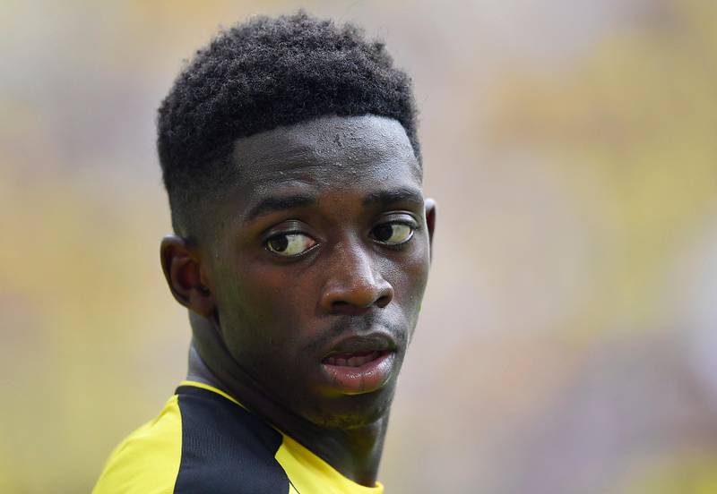FILE - In this Aug. 27, 2016 file photo Borussia Dortmund's Ousmane Dembele watches during the German Bundesliga soccer match against FSV Mainz in Dortmund, Germany. Borussia Dortmund's CEO Hans-Joachim Watzke said at the annual balance press conference today, that he is optimistic about the record transfer of the 20-year-old Ousmane Dembele to FC Barcelona very soon. (AP Photo/Martin Meissner, file)
