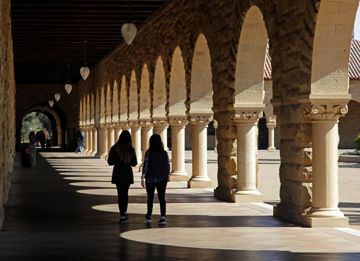 FILE - In this March 14, 2019, file photo students walk on the Stanford University campus in Santa Clara, Calif. In a study released Monday, Aug. 24, 2020, the Interfaith Diversity Experiences and Attitudes Longitudinal Survey (IDEALS) said U.S. college students spend a significant time learning about people of different races, political affiliations and sexual orientations and much less time learning about people of different religious and worldview groups. Researchers also said that college students show â€œhigh levels of respect and goodwill toward people who hold diverse religious perspectives.â€   (AP Photo/Ben Margot, File)