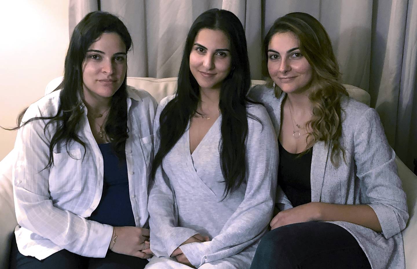 Amer Fakhoury's daughters, Guila, Macy, and Zoya Fakhoury, gather in Salem, New Hampshire. He was accused of torturing and killing inmates at a former prison where his family says he had worked as a clerk. AP