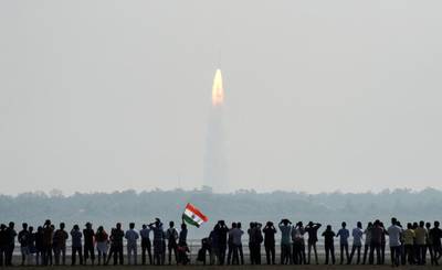 Indian onlookers watch the launch of the Indian Space Research Organisation (ISRO) Polar Satellite Launch Vehicle (PSLV-C37) at Sriharikota on Wednesday. Arun Sankar / AFP