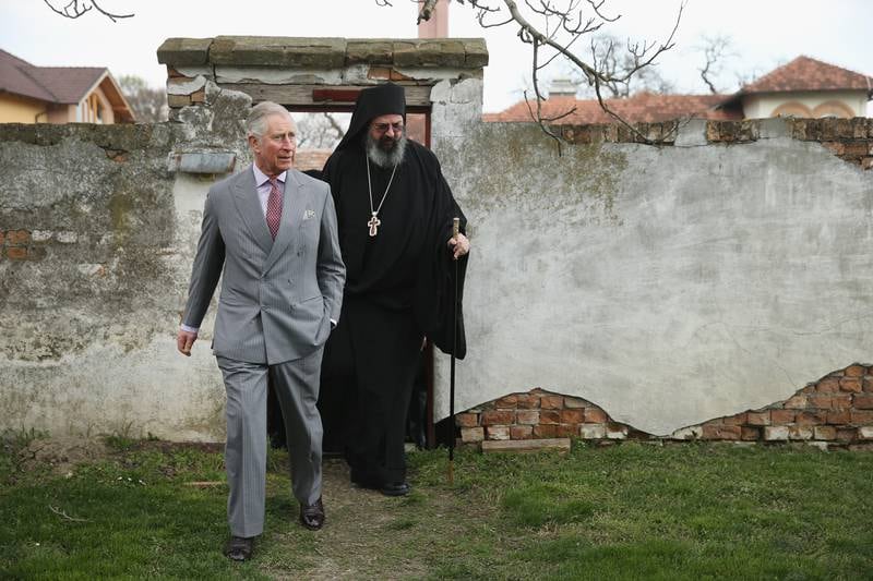 Prince Charles tours the Kovilj Monastery grounds with the abbot of the monastery, Father Isihije Hesychios, in Kovilj, Serbia, in 2016.