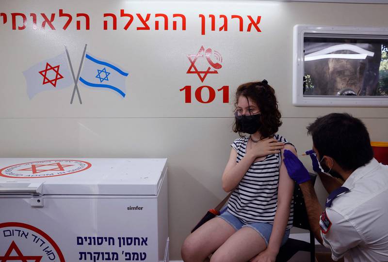 An Israeli girl receives a dose of the Pfizer/BioNTech Covid-19 vaccine. Israel is now urging more 12- to 15-year-olds to be vaccinated, citing new outbreaks attributed to the more infectious Delta variant.