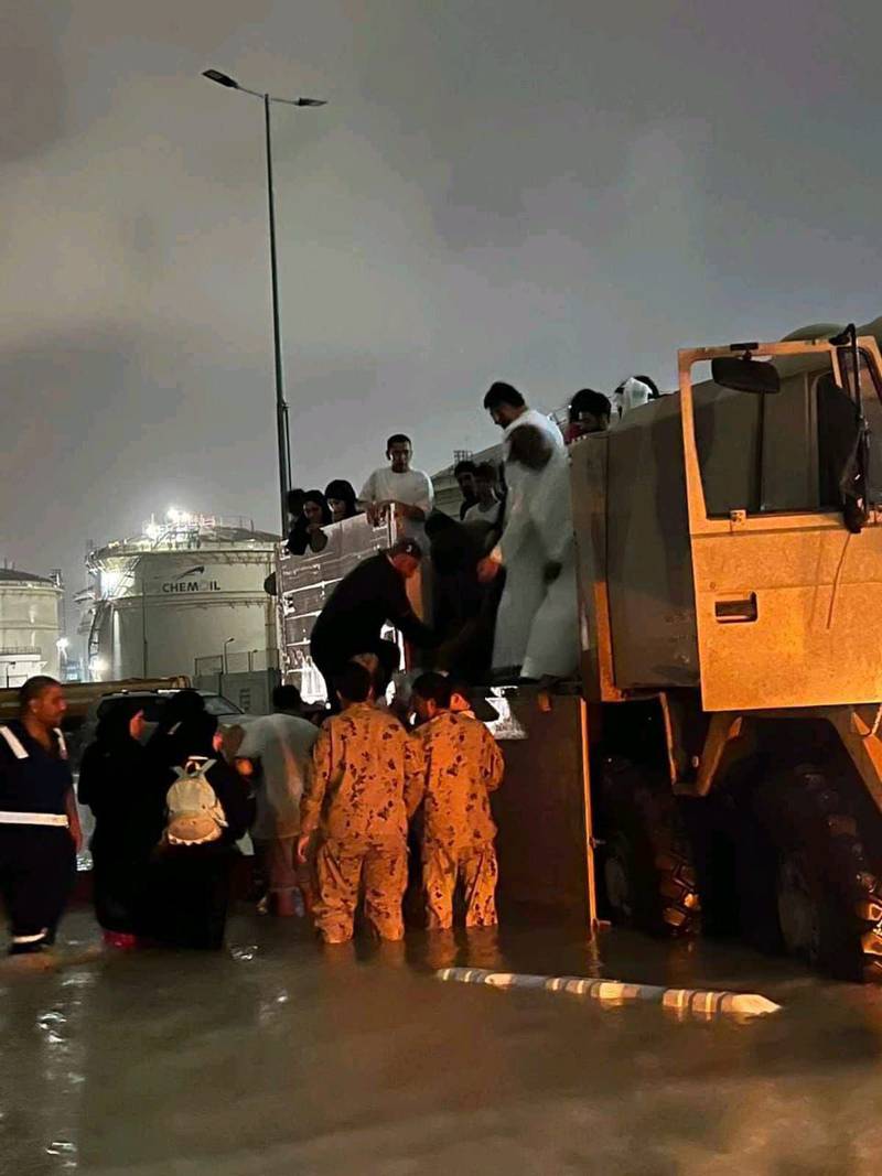 Servicemen rescue residents from the floodwaters in the Northern Emirates. 