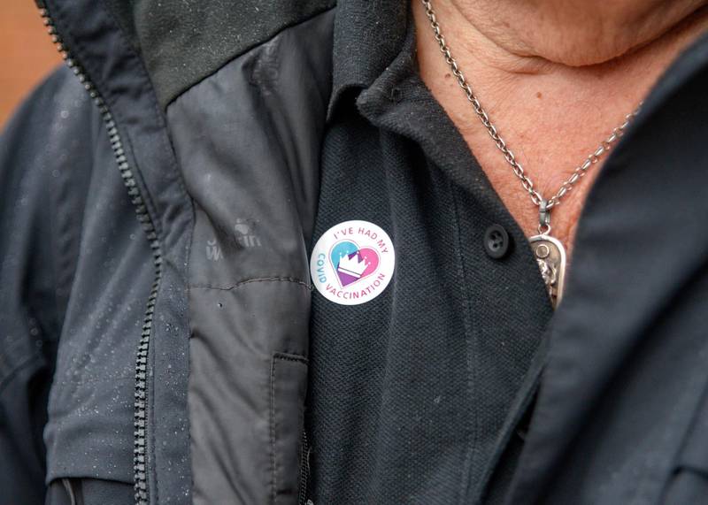 A Cranleigh resident wearing a vaccination sticker. Martin Bamford for The National