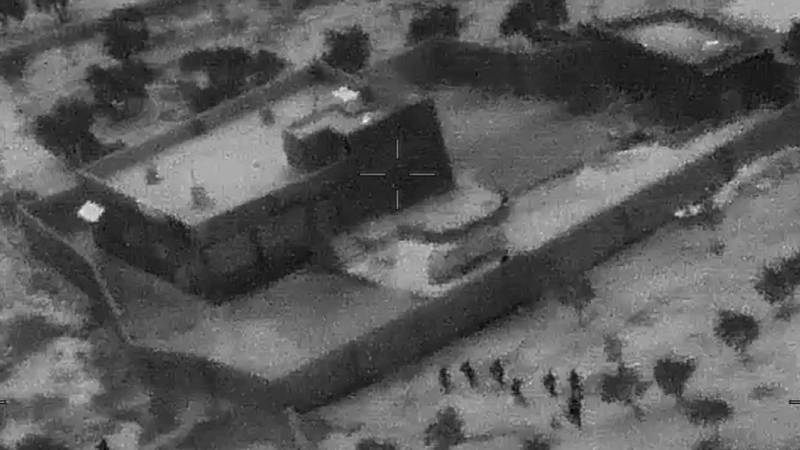 FILE - This Oct. 26, 2019, file image from video released by the Department of Defense, and displayed at a Pentagon briefing, shows U.S. Special Forces, figures at lower right, moving toward compound of Islamic State leader Abu Bakr al-Baghdadi. In his last months on the run, al-Baghdadi was agitated, fearful of traitors, sometimes disguised as a shepherd, sometimes hiding underground, always dependent on a shrinking circle of confidants. (Department of Defense via AP, File)