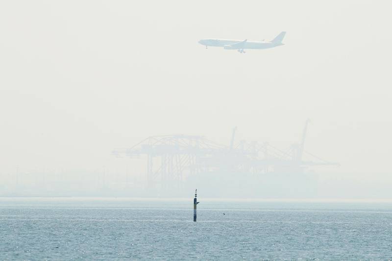 A plane is seen over smoke covered Botany Bay as it comes in to land in at Sydney Airport on November 19, 2019 in Sydney, Australia. Getty Images