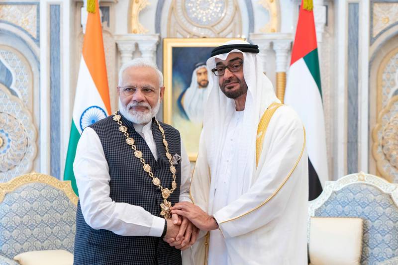 ABU DHABI, UNITED ARAB EMIRATES - August 24, 2019: HH Sheikh Mohamed bin Zayed Al Nahyan, Crown Prince of Abu Dhabi and Deputy Supreme Commander of the UAE Armed Forces (R), presents a Zayed Medal to HE Narendra Modi, Prime Minister of India (L), during a reception at Qasr Al Watan.

( Rashed Al Mansoori / Ministry of Presidential Affairs )
---