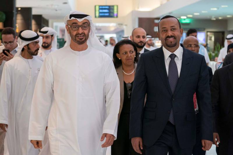 ABU DHABI, UNITED ARAB EMIRATES - March 18, 2019: HH Sheikh Mohamed bin Zayed Al Nahyan, Crown Prince of Abu Dhabi and Deputy Supreme Commander of the UAE Armed Forces (L) and HE Abiy Ahmed, Prime Minister of Ethiopia (R), tour the Special Olympics World Games Abu Dhabi 2019, at Abu Dhabi National Exhibition Centre (ADNEC). Seen with HH Sheikh Khalifa bin Tahnoon bin Mohamed Al Nahyan, Director of the Martyrs' Families' Affairs Office of the Abu Dhabi Crown Prince Court (back L).

( Ryan Carter / Ministry of Presidential Affairs )?
---