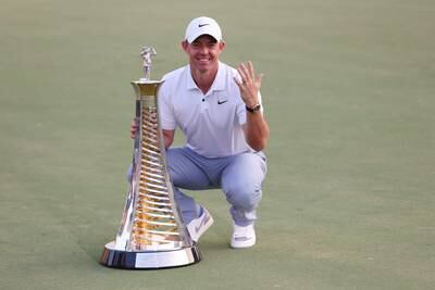 Rory McIlroy of Northern Ireland poses with the Race to Dubai trophy on the 18th green on the Earth Course at Jumeirah Golf Estates on November 19, 2023. Getty Images