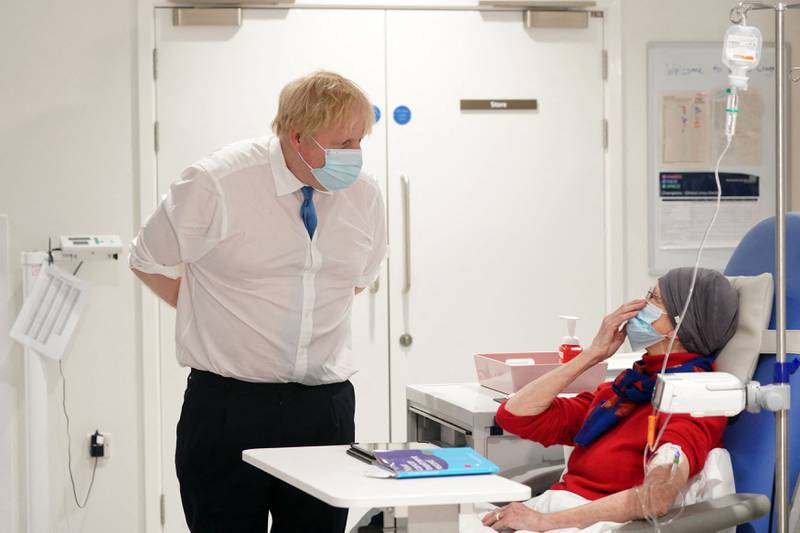 Mr Johnson speaks to patient Kathryn Wills during visit to a cancer hospital in Carlisle, northern England. AFP